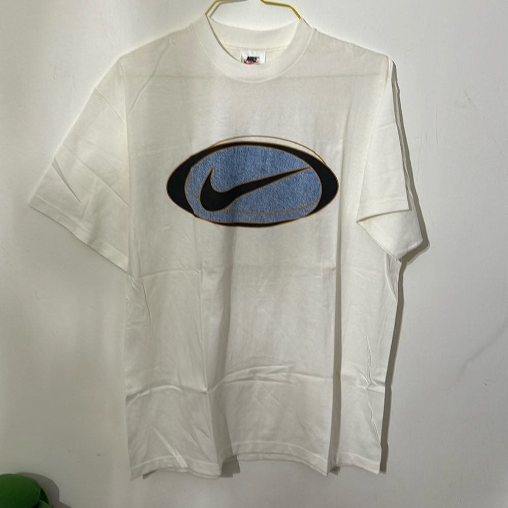Brand new Nike T-shirt with Nike logo in black,gold, and blue,size is large.